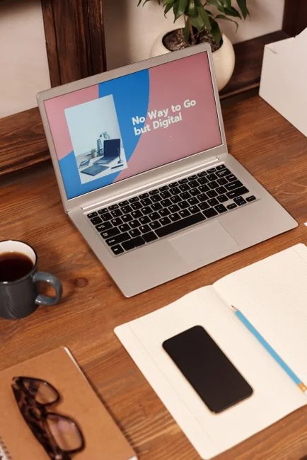 Stylish and efficient workspace with multiple monitors, laptop, and smartphone, showcasing a web design project.